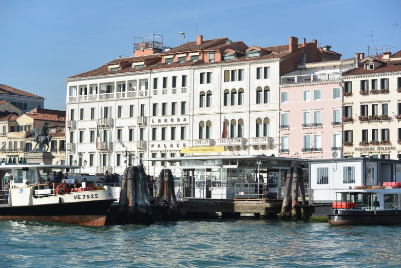 two boats are in front of some very large buildings