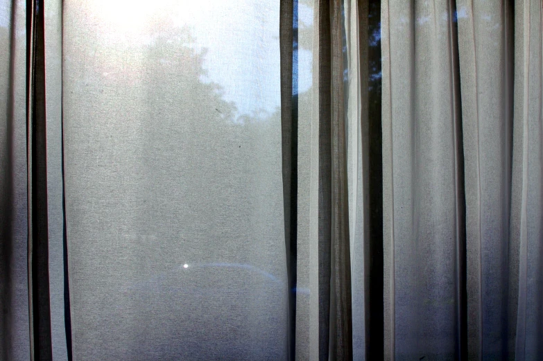 the back side of a window with black curtains