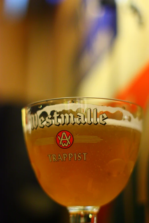 a glass with soing that says weenniallale trappist