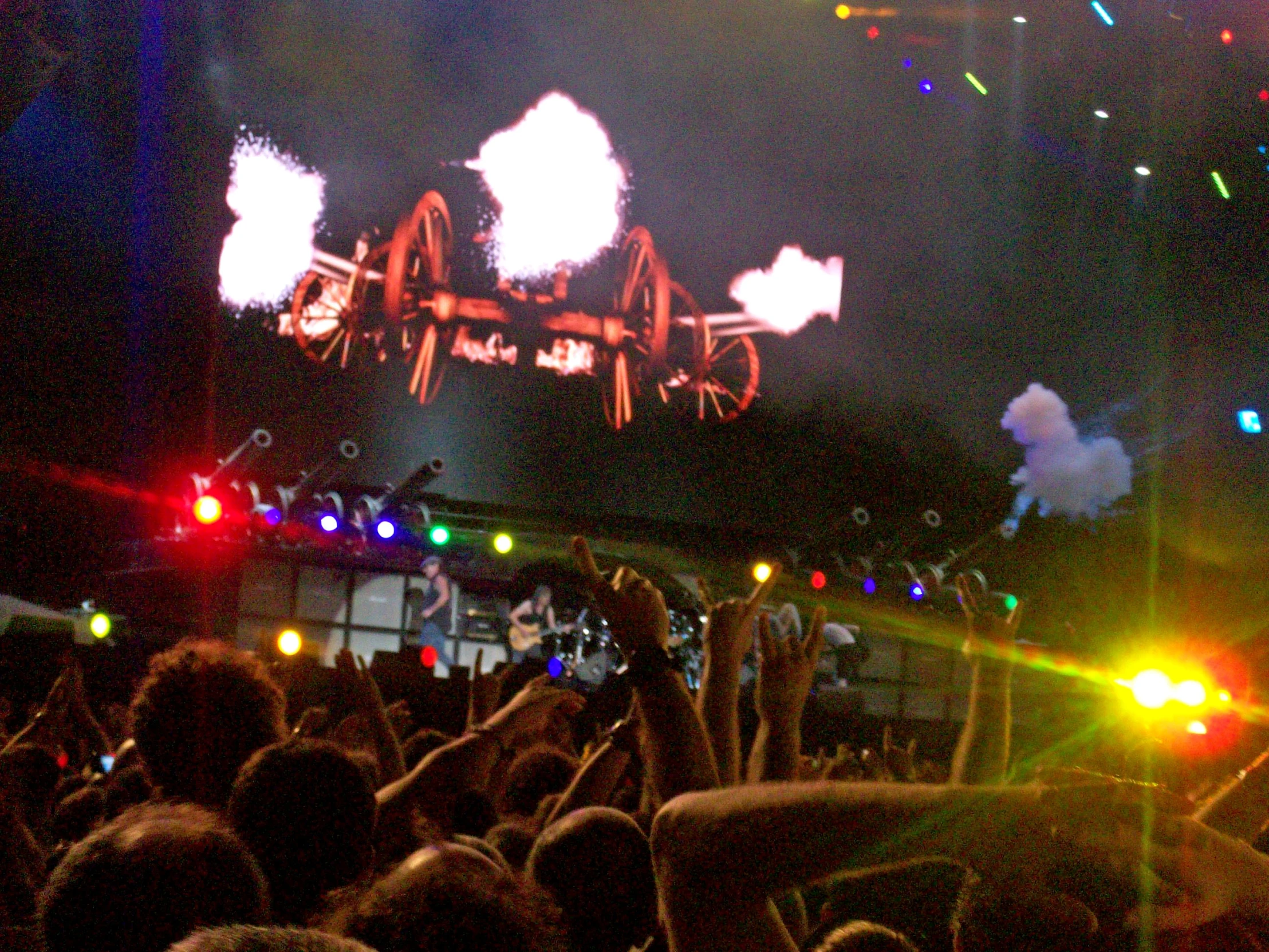 a large crowd is watching fireworks at a concert