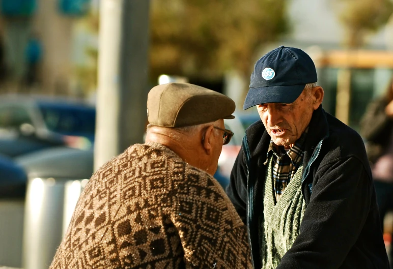 two older men talk next to each other