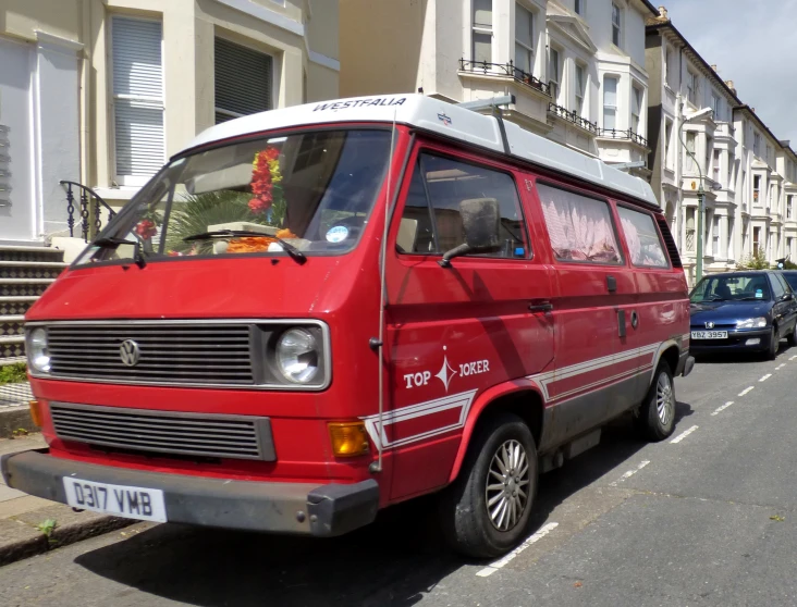 a red van driving down a city street