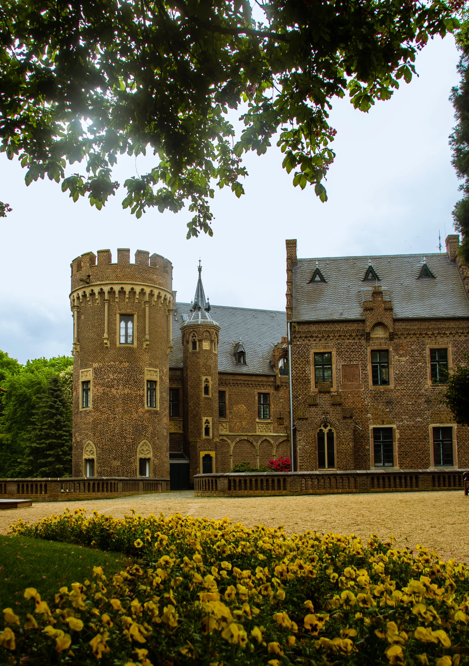 a large brown brick building with a tower