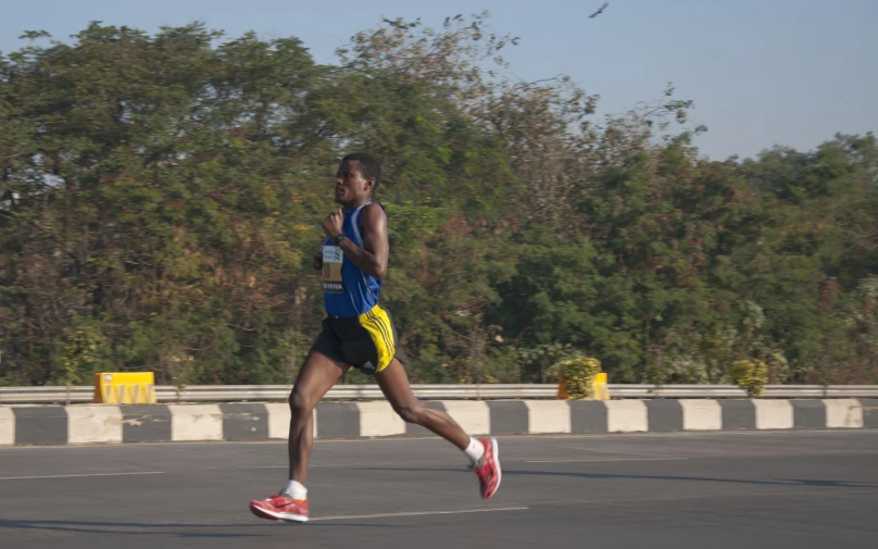 a man wearing a vest running through the street