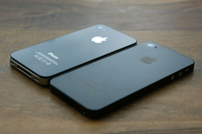 a close up of two iphones sitting on a table