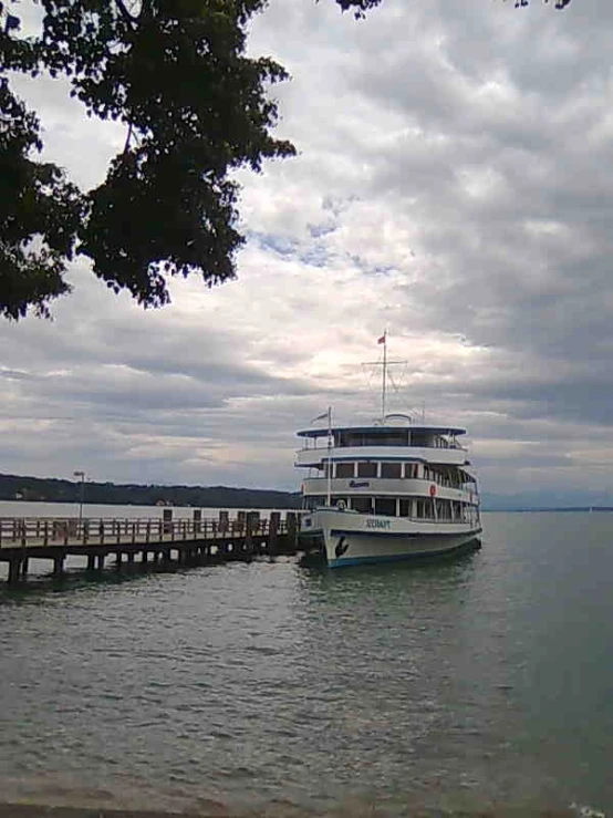 the large boat is moored in a river