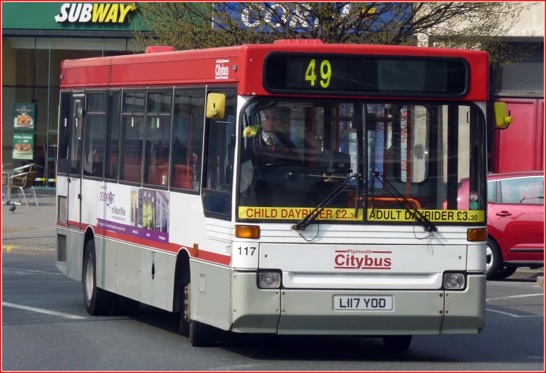 a large city bus in the city on the road