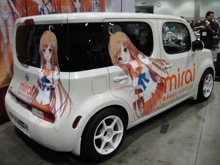 the rear end of a minivan with anime posters on it