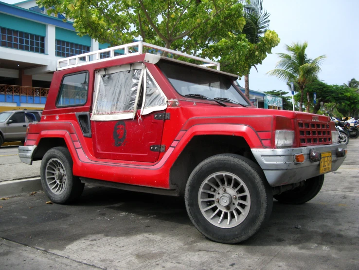 a red jeep that is parked on the side of the road