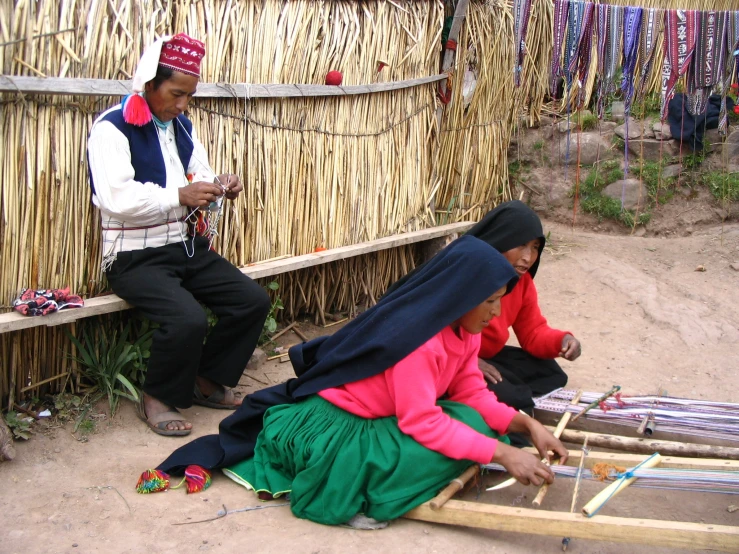 two people sit on wooden steps by a building