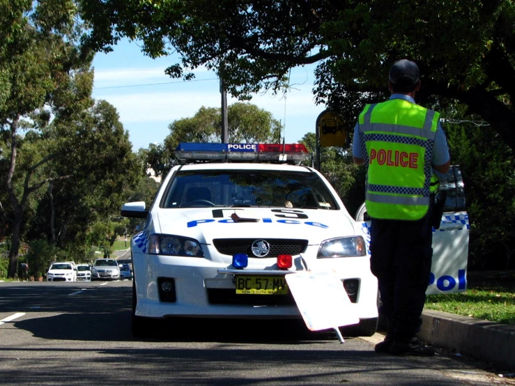 a police officer is directing traffic on the road