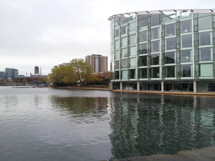 the building next to the water has long glass walls