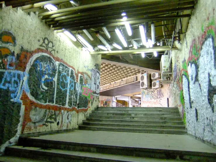 a large, graffiti covered stair rail in a subway