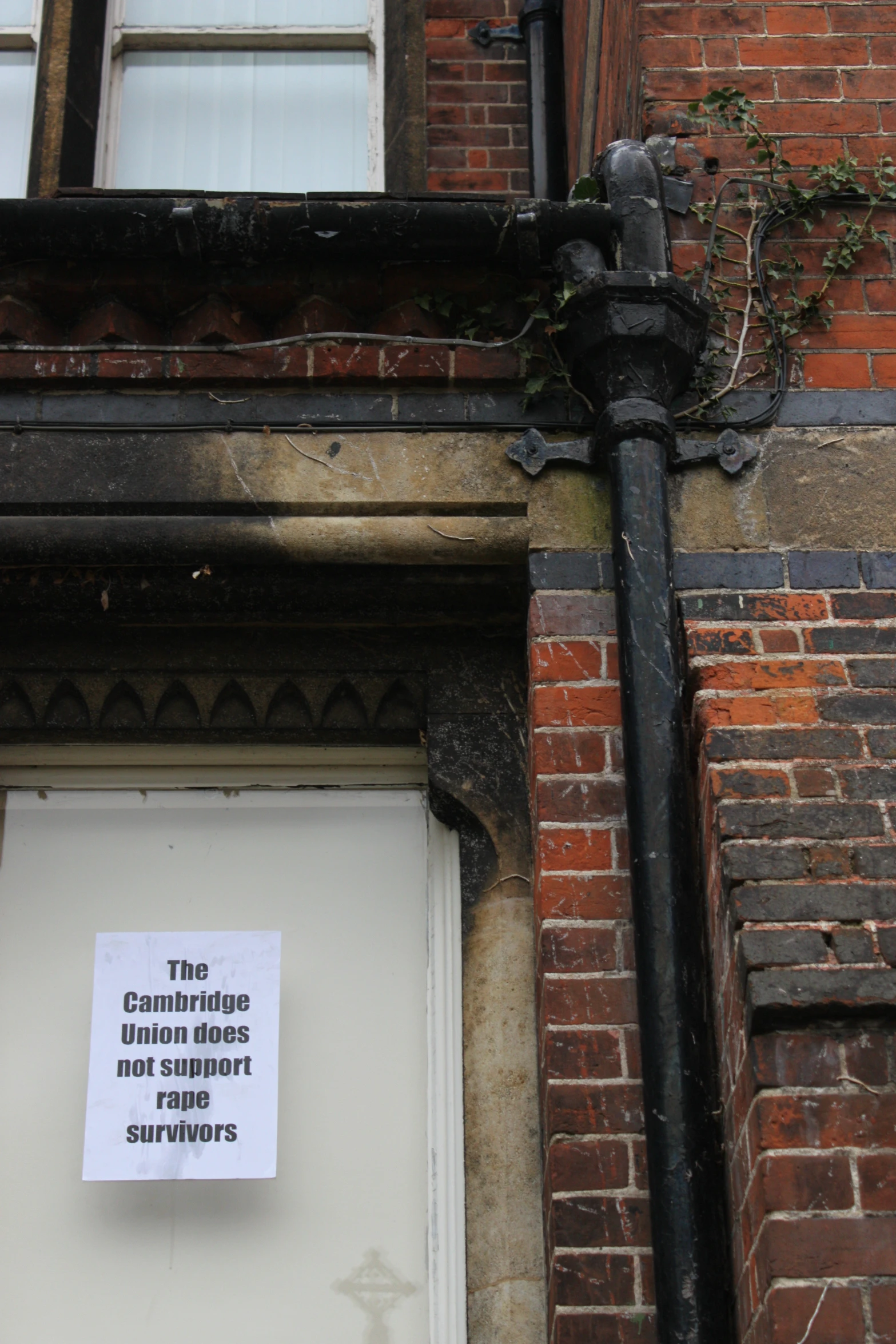 the sign is attached to the corner of the building