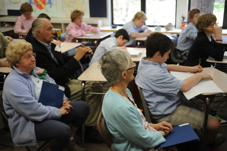 a group of older people are in a classroom