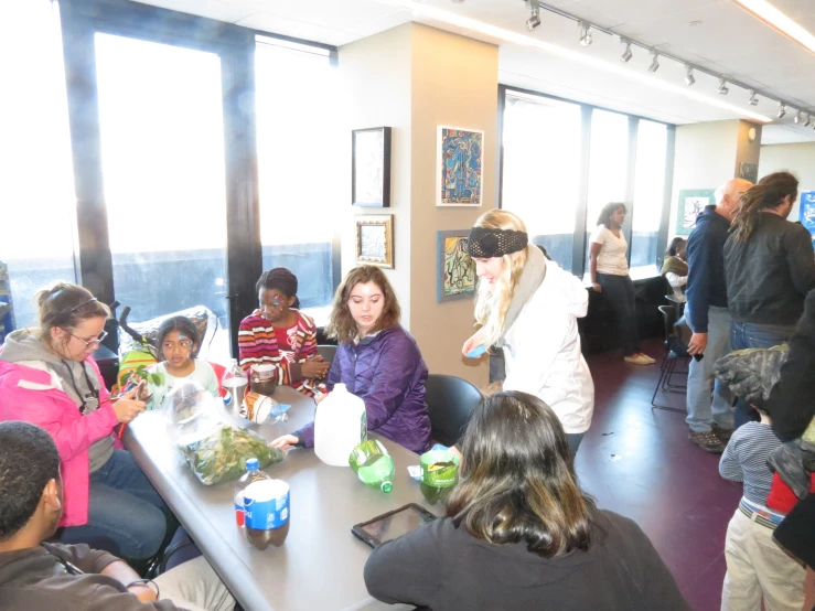 a group of people around a table, eating food