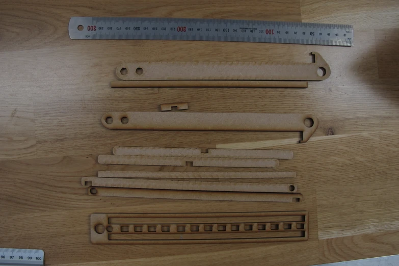 wooden rulers are cut up and taped together