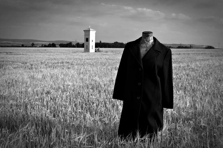 a man standing in the middle of a field with his suit up