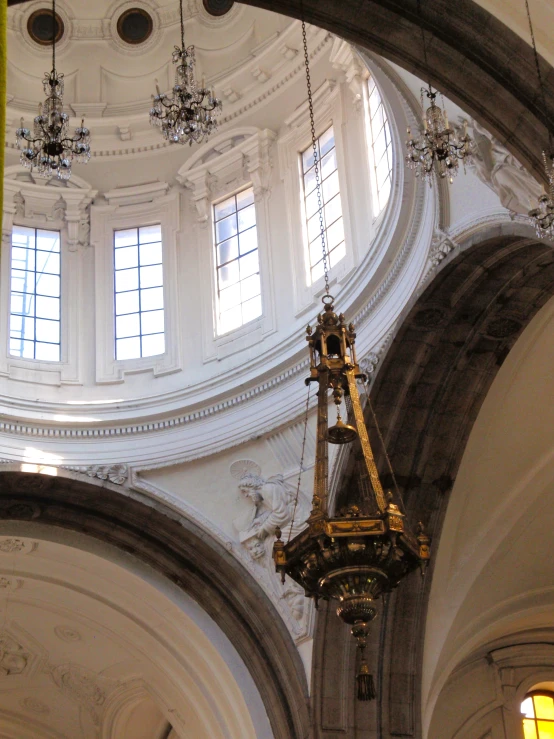 a chandelier hangs from the ceiling in an ornate building