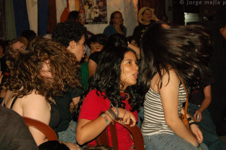 several girls and one man sitting next to each other