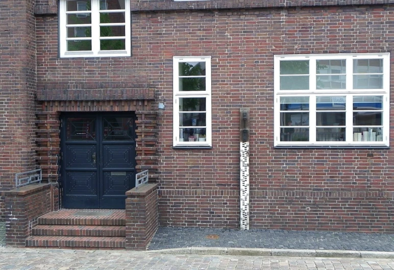 an empty brick building with an exit sign