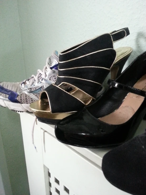 a pair of black heels are sitting on a table