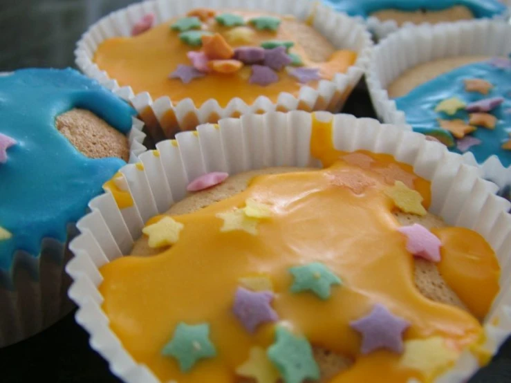 a number of cups with cupcakes decorated to look like moon's