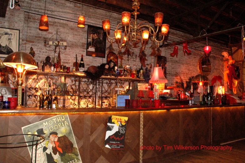 a bar filled with lots of books and a glass vase on the counter