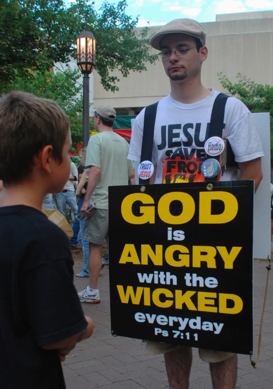 a man stands next to a small boy as they protest