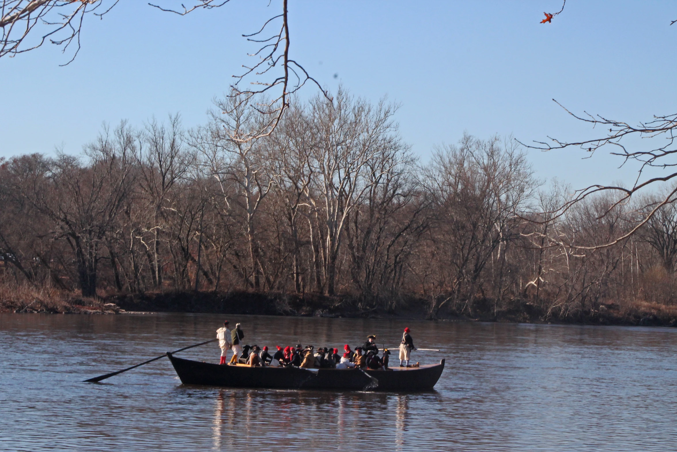 people are riding on top of the boat in a lake