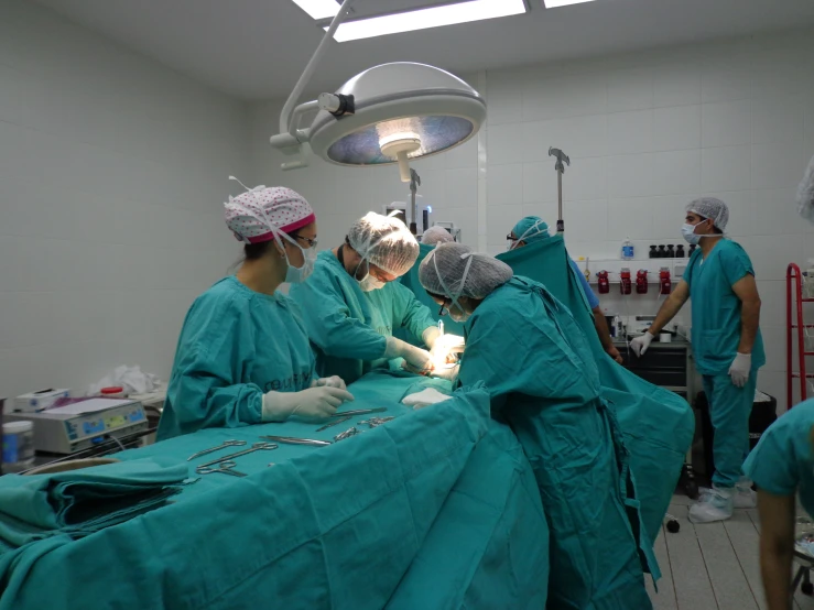 some surgeons doing  in an operating room