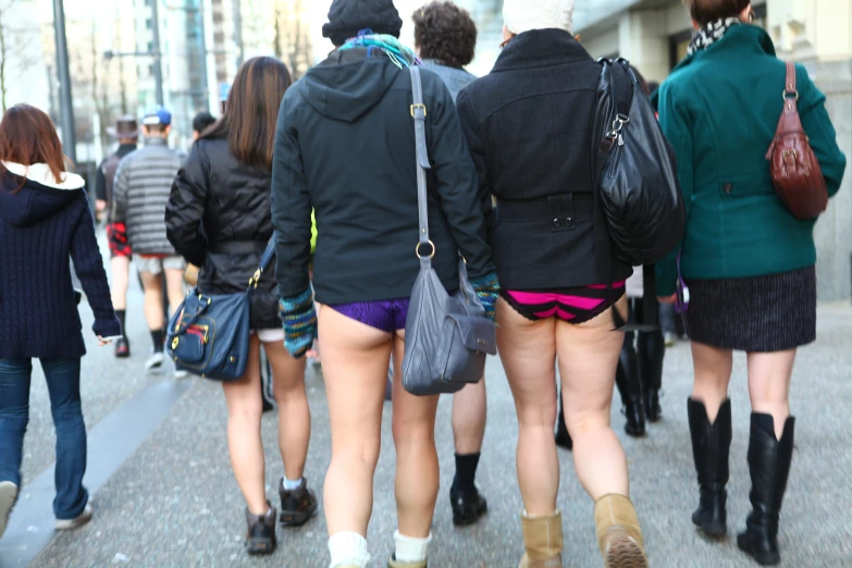 several young women in short shorts walking down the street