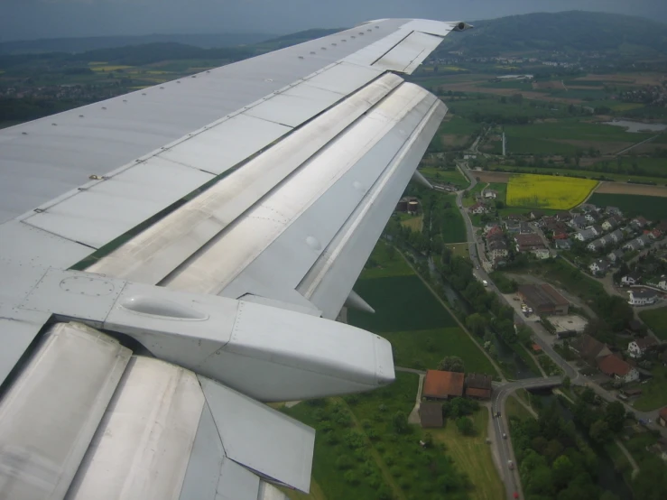 the wing of an airplane looking out over a city