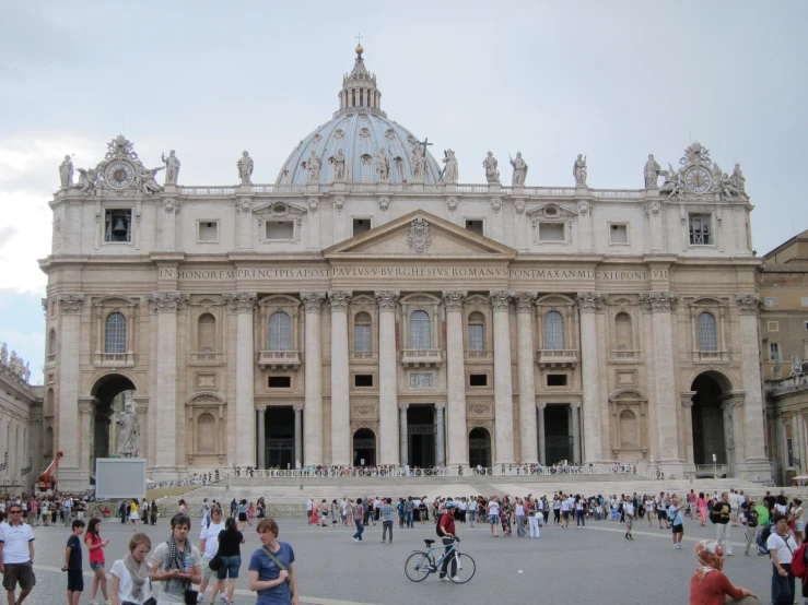 people standing in front of a building near people walking around