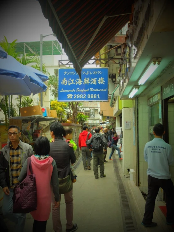 there are many people walking in the shopping mall