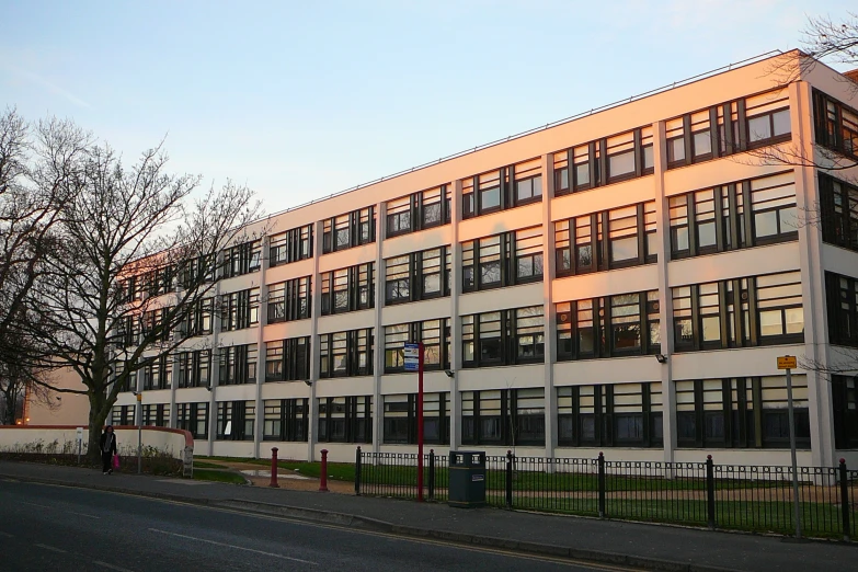 a modern building with a fence in front of it