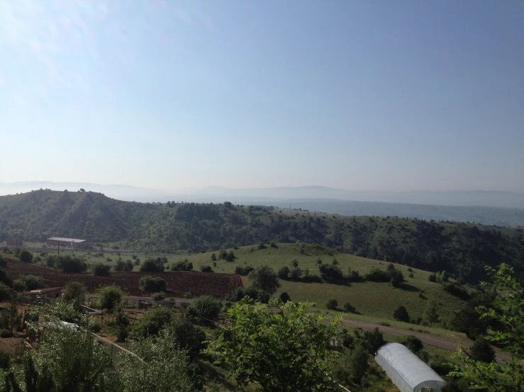 a large hill near the trees is covered in hills