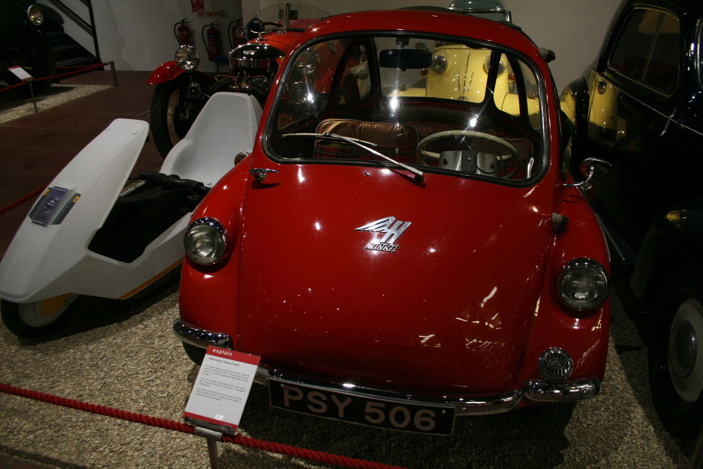 two old cars on display and some new ones to see