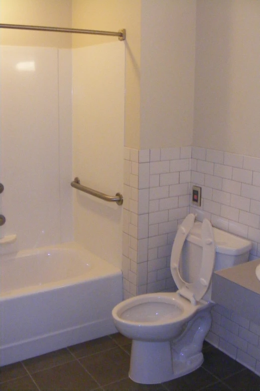 there is a bathroom with the shower and the toilet