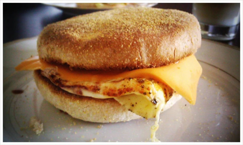 a breakfast sandwich is topped with fried eggs and melted cheese