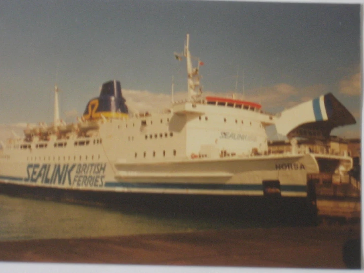 a large white boat in a marina next to a dock