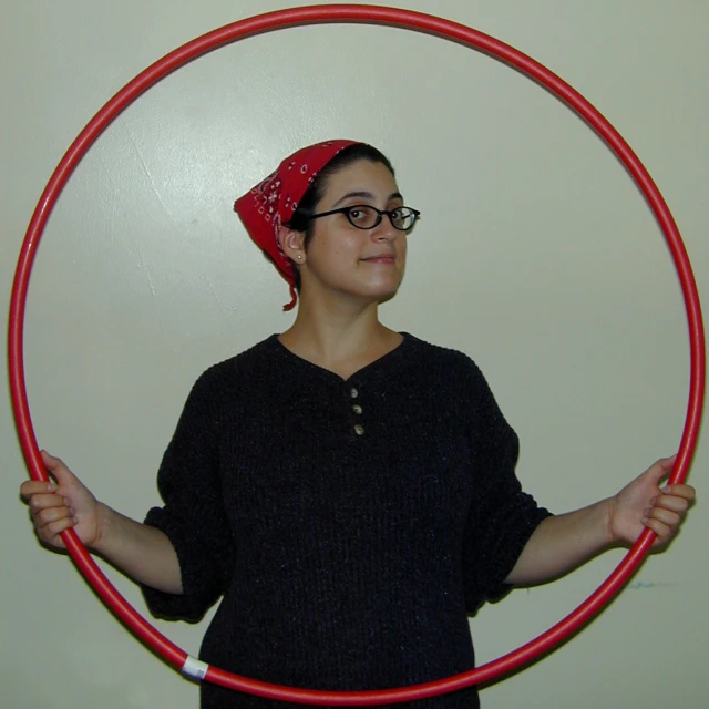 a person with glasses is holding a hoop