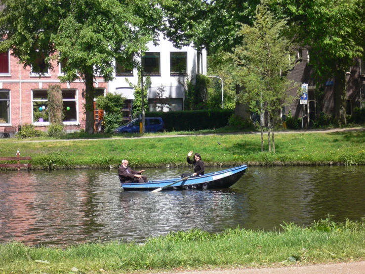 a boat full of people floats on a small river