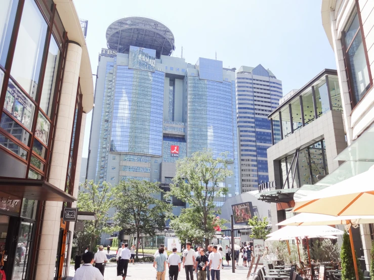 a city street with buildings and people walking