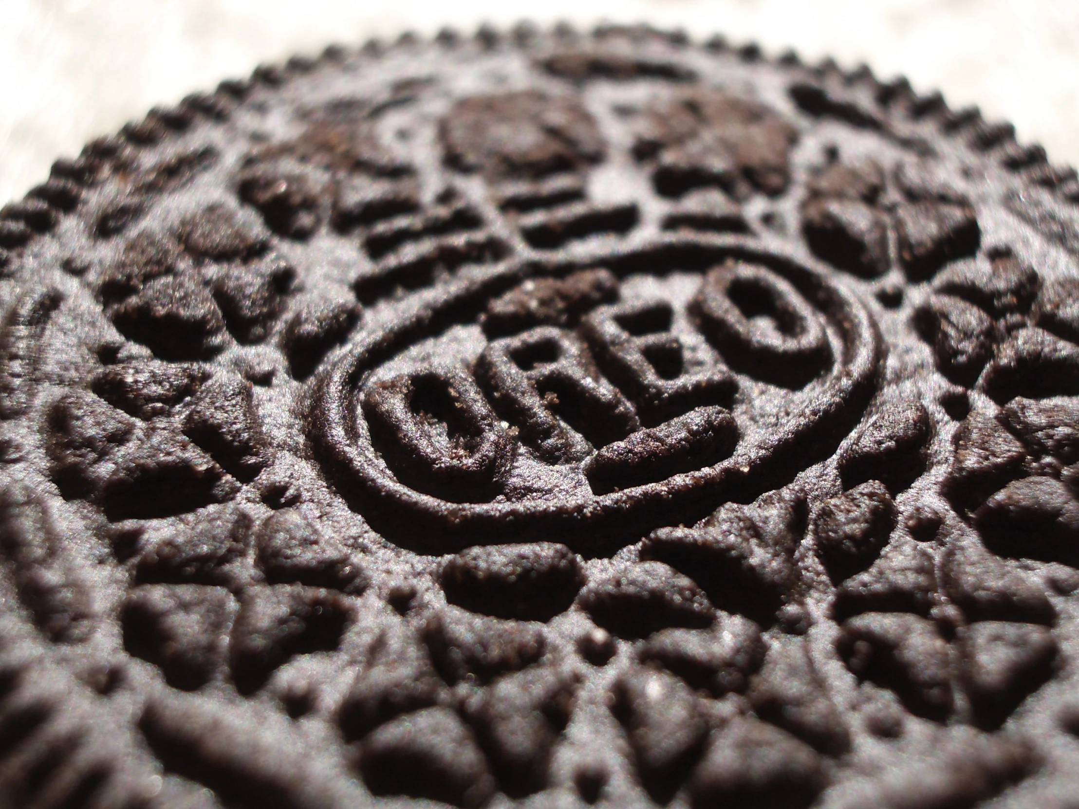 a closeup of a chocolate biscuit that reads'doritos '