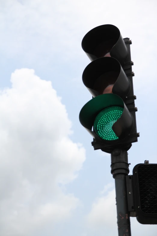 a traffic light hanging off of a metal pole