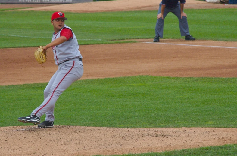 a baseball player throwing a pitch from the mound