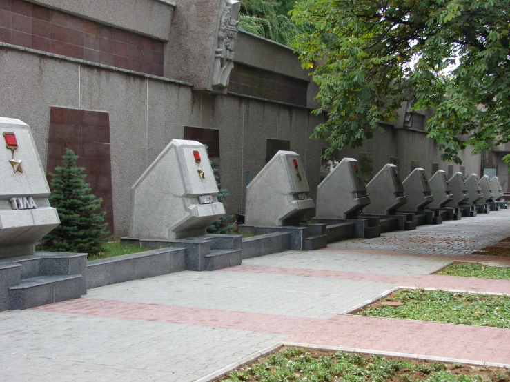 many stone urns placed in a row outside