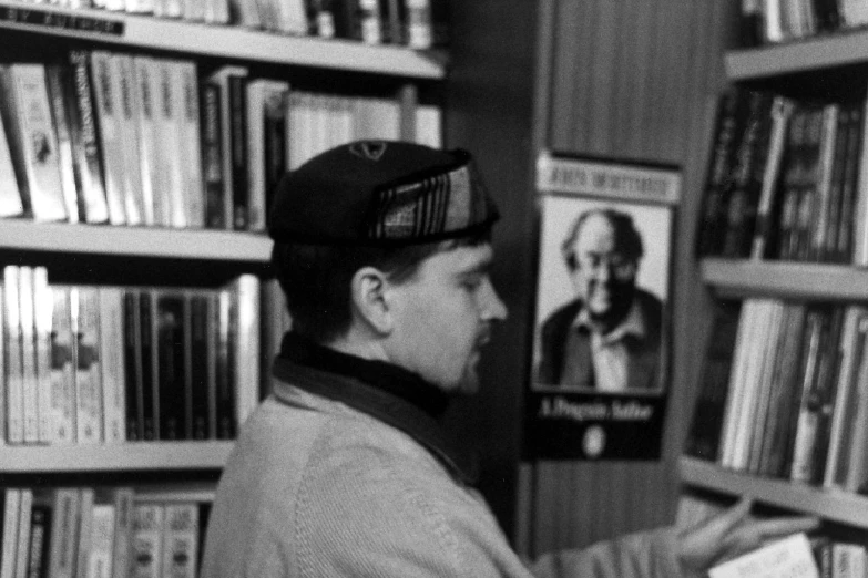 a man looking at books in the liry