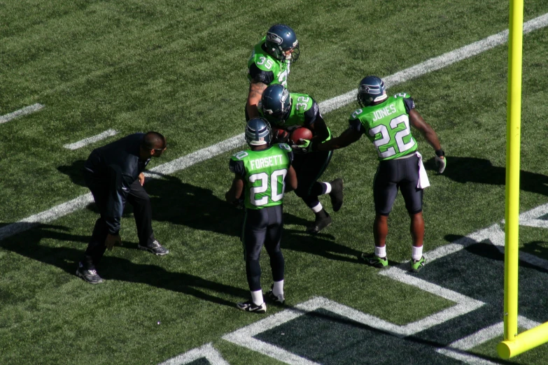 a group of football players standing around each other